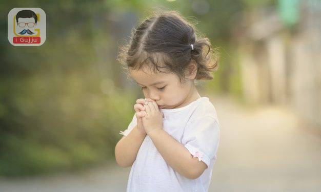 Cute asian little girl closed her eyes and praying in the morning. Little asian girl hand praying,Hands folded in prayer concept for faith,spirituality and religion.