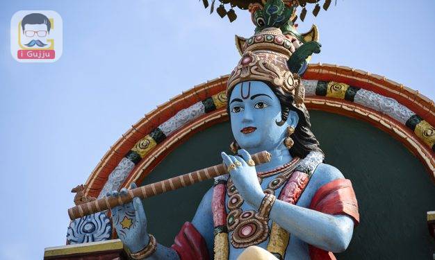 Detail stone statue in Sri Krishnan temple on south indian hindu temple in Singapore on blue sky background, close up